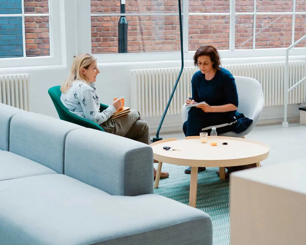 Two people talking in a couch